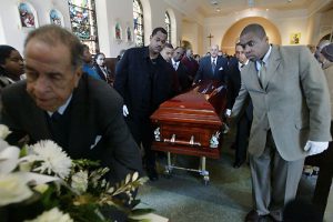 Jane Tyska-staff 3/11/06 Tribune News Funeral director Louis Charbonnet, (center, rear) escorts the casket of Ethel Anna Herbert from Our Lady of Guadalupe Church in New Orleans after her funeral on Feb. 11. Herbert's story received national attention after she was airlifted out of the Superdome alive, but wound up missing for almost six months. Her daughter tried to give a FEMA representative her mother's medication with her name on it, but they declined to take it. Herbert died in route and wound up in the morgue in Baton Rouge, where she had been since Sept. 5. Her family is now speaking out for the remainder of Katrina's missing.